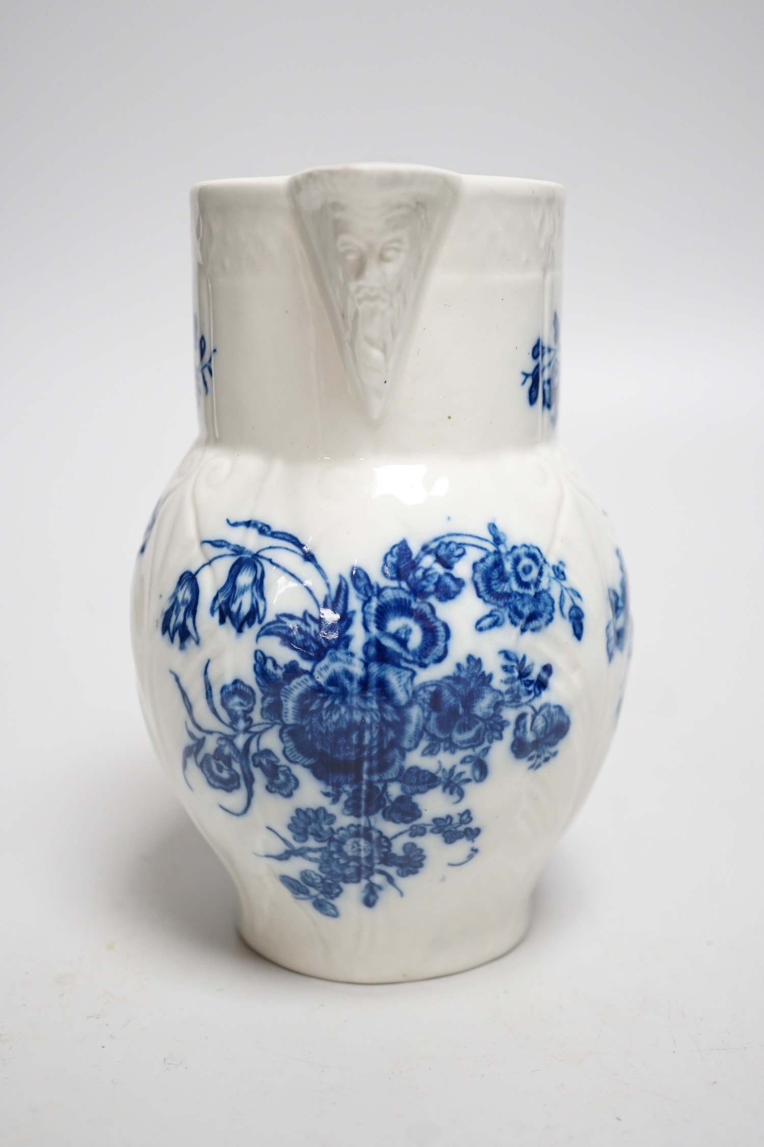 An 18th century Caughley mask jug printed with bouquets, C mark to base, 14.5cms high